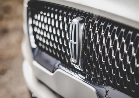 The grille of the 2024 Lincoln Aviator® Reserve model with an eye-catching repeated field of Lincoln Star logo shapes | Varsity Lincoln in Novi MI