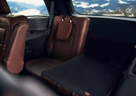 The left rear seat of a 2024 Lincoln Aviator® SUV is shown folded flat for additional cargo space | Varsity Lincoln in Novi MI