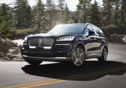 A Lincoln Aviator® SUV is being driven on a winding mountain road | Varsity Lincoln in Novi MI