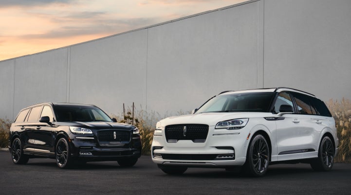 Two Lincoln Aviator® SUVs are shown with the available Jet Appearance Package | Varsity Lincoln in Novi MI