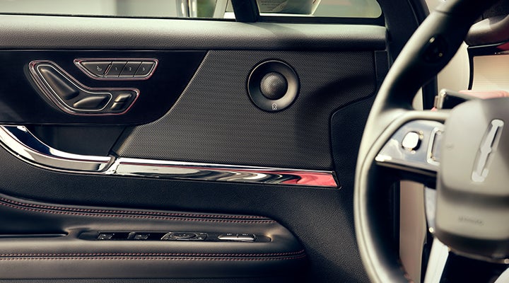A Revel® audio speaker is shown in the driver’s side door of a 2024 Lincoln Corsair® SUV. | Varsity Lincoln in Novi MI