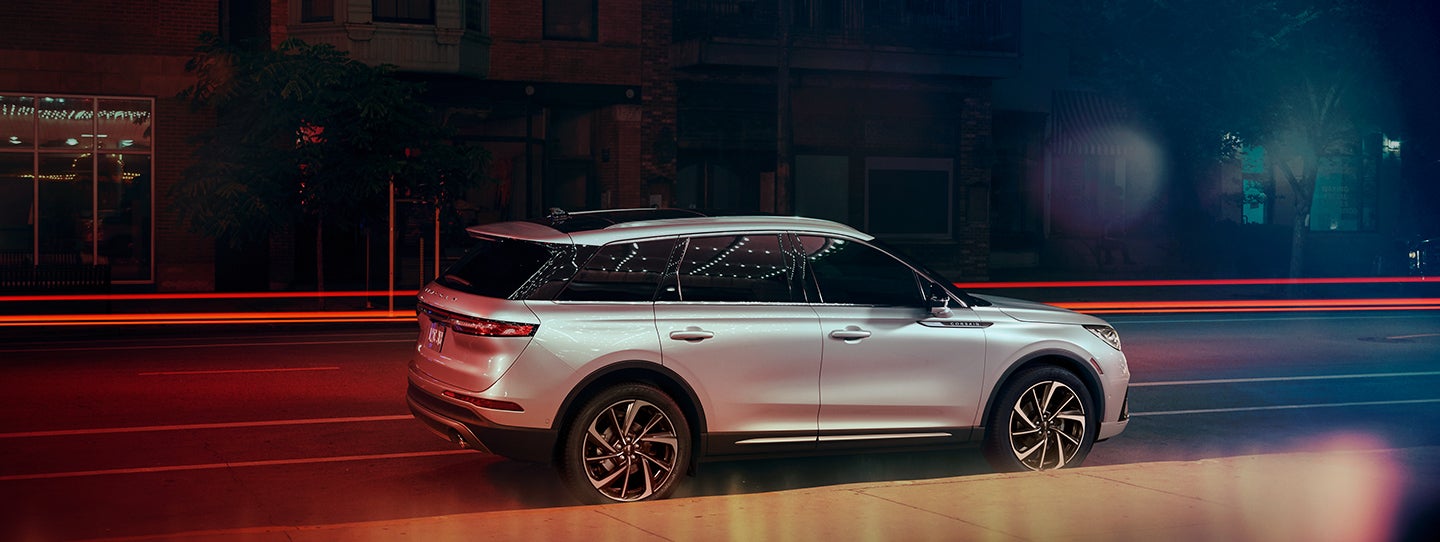 The 2024 Lincoln Corsair® SUV is parked on a city street at night. | Varsity Lincoln in Novi MI