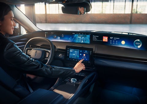 The driver of a 2024 Lincoln Nautilus® SUV interacts with the center touchscreen. | Varsity Lincoln in Novi MI