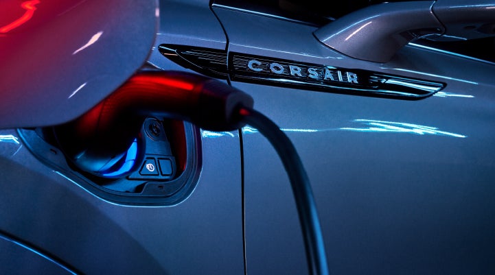 A charger plugged into the charging port of a 2024 Lincoln Corsair® Plug-in Hybrid model. | Varsity Lincoln in Novi MI