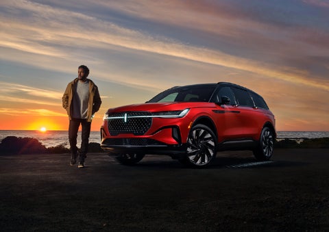 A person is shown next to a 2025 Lincoln Nautilus® SUV as the Lincoln Embrace sequence takes place. | Varsity Lincoln in Novi MI