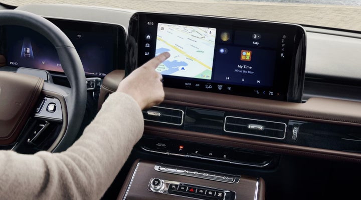 A person is tapping the center display touchscreen of a 2026 Lincoln Aviator® SUV. | Varsity Lincoln in Novi MI