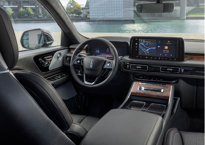The interior of the 2026 Lincoln Aviator® SUV is shown parked with a view of a harbor through the windshield. | Varsity Lincoln in Novi MI