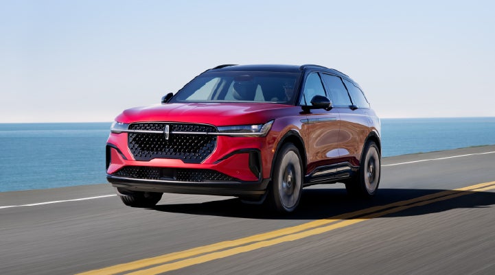 A 2026 Lincoln Nautilus® SUV is being driven on a seaside roadway. | Varsity Lincoln in Novi MI