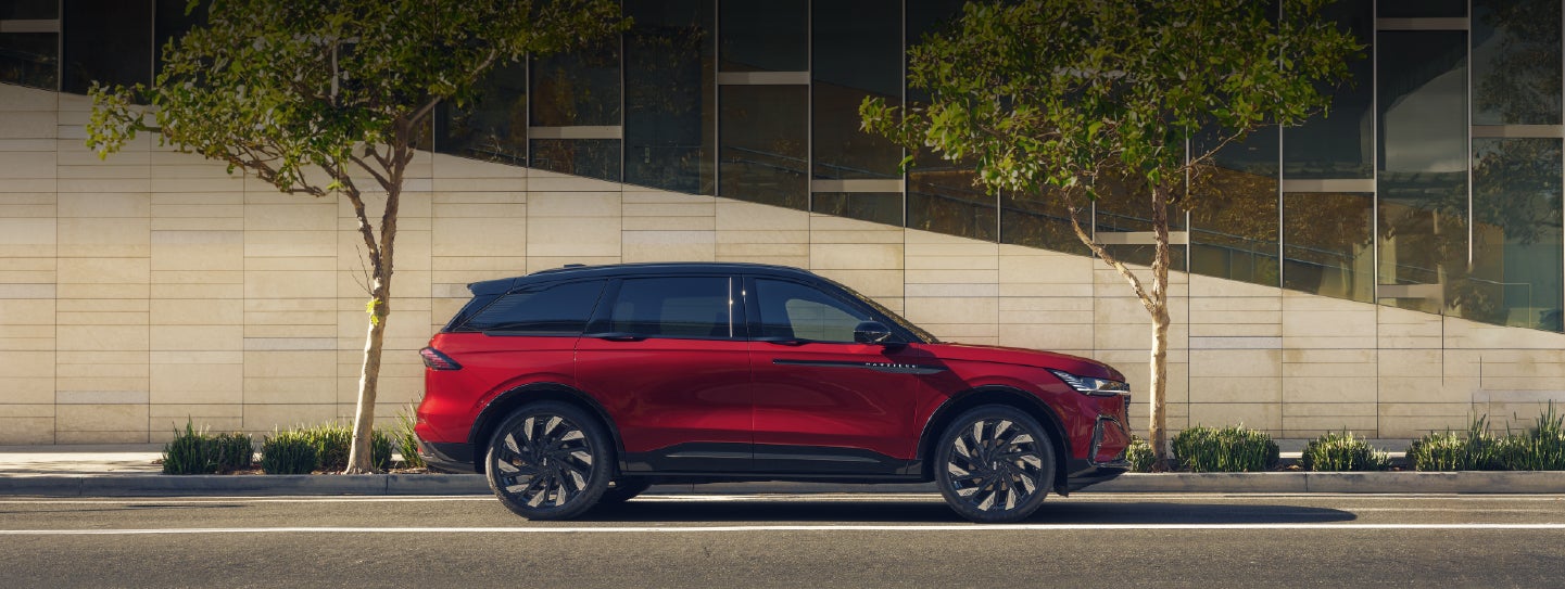 A 2026 Lincoln Nautilus® SUV with an available Hybrid Powertrain is parked in an urban setting. | Varsity Lincoln in Novi MI