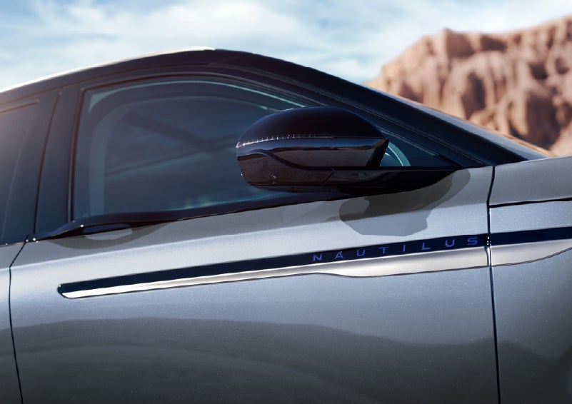 Blue lettering on the side of the vehicle that reads Nautilus indicates the available Hybrid Powertrain. | Varsity Lincoln in Novi MI