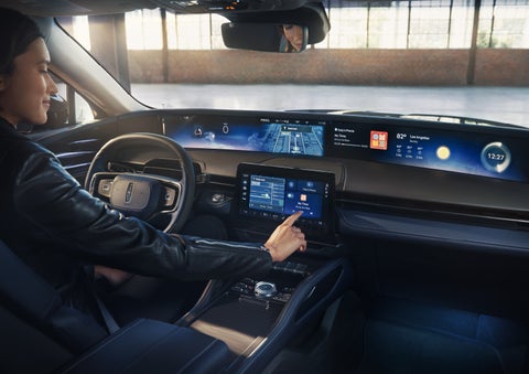 The driver of a 2026 Lincoln Nautilus® SUV interacts with the center touchscreen. | Varsity Lincoln in Novi MI