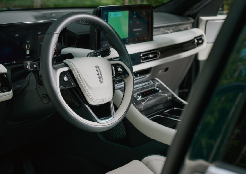 The leather-trimmed steering wheel of a 2027 Lincoln Aviator® Black Label™ SUV. | Varsity Lincoln in Novi MI
