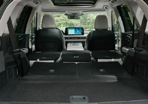 A rear to front view of the interior of a 2027 Lincoln Aviator® Black Label™ SUV shows the third and second rows folded flat | Varsity Lincoln in Novi MI